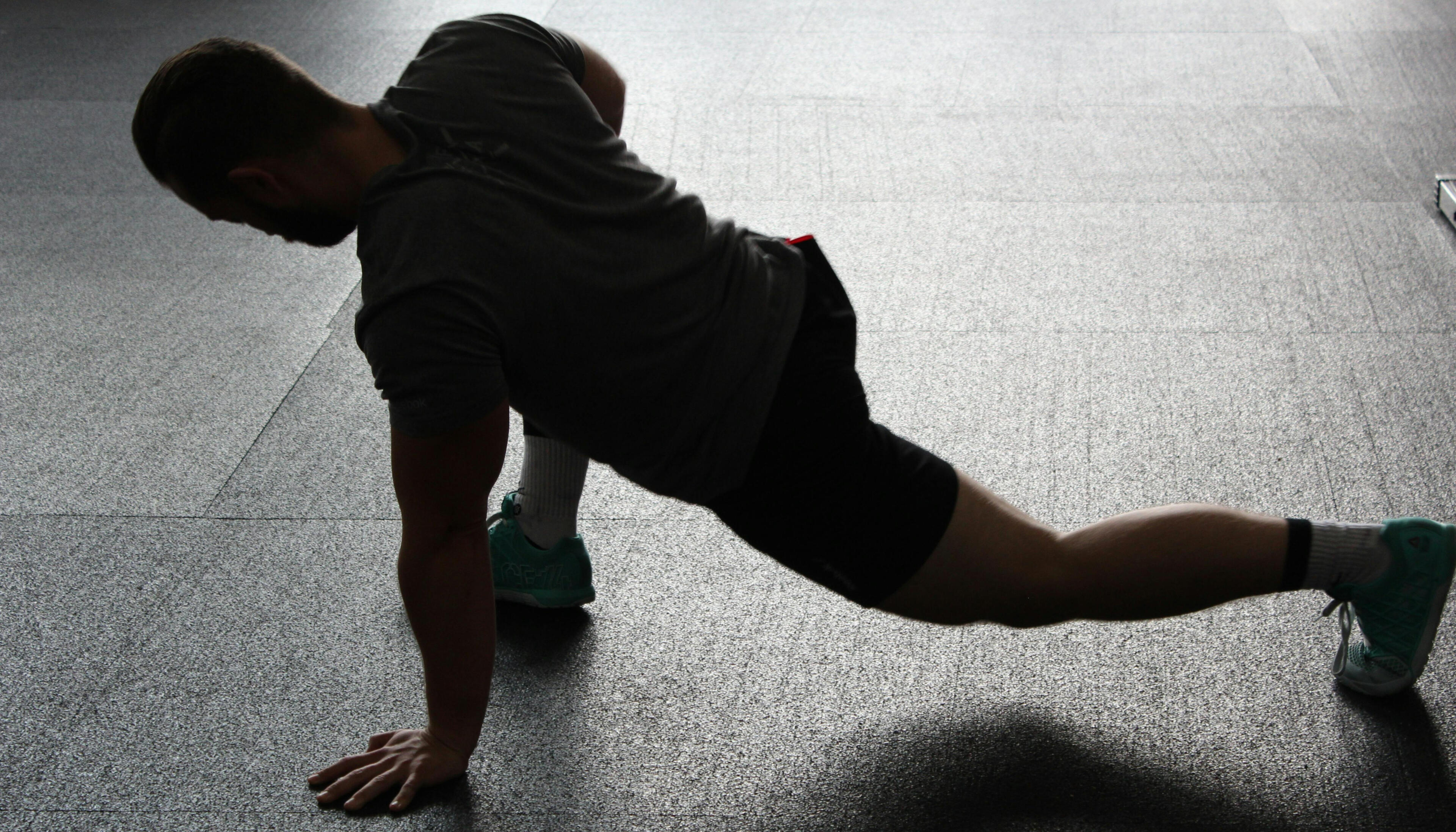 Injury prevention training A person on the floor stretching and enhancing their mobility to help prevent injury.